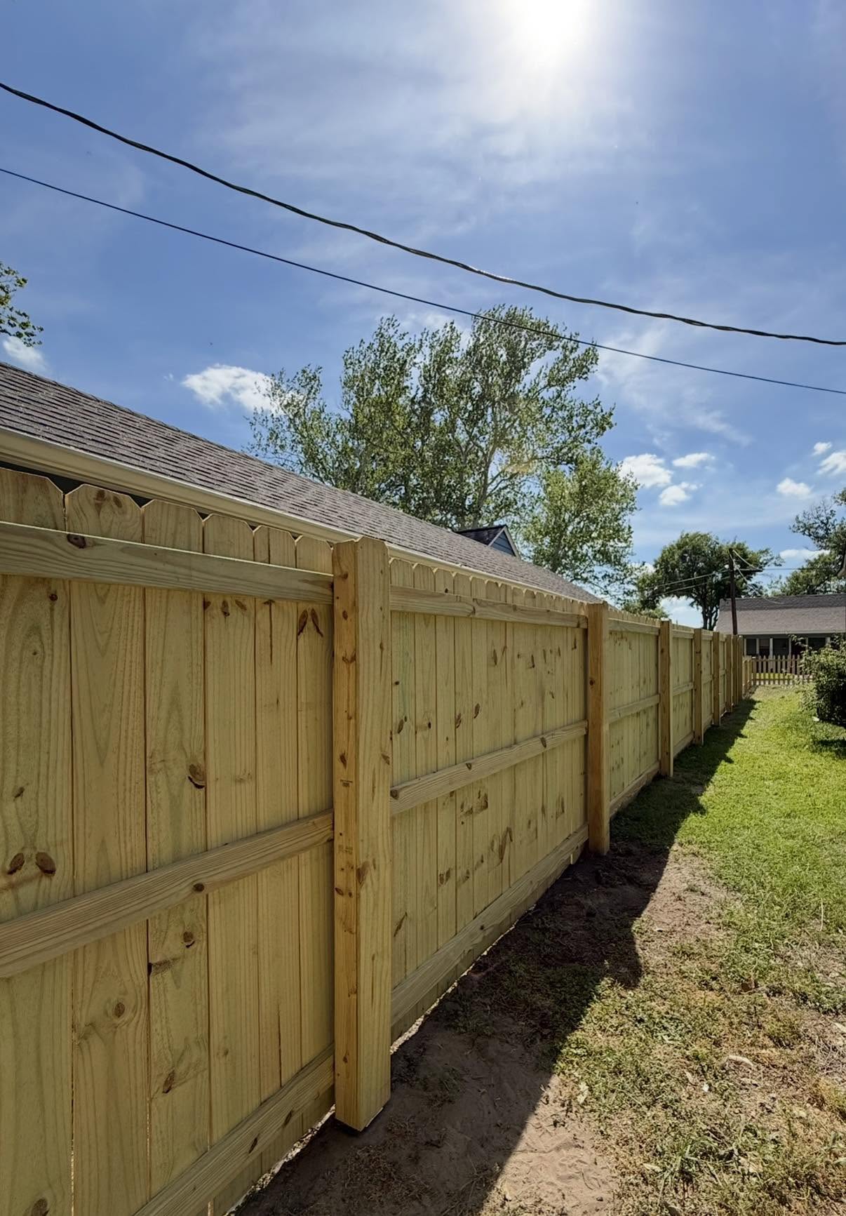 New capped wood privacy fence in full sun