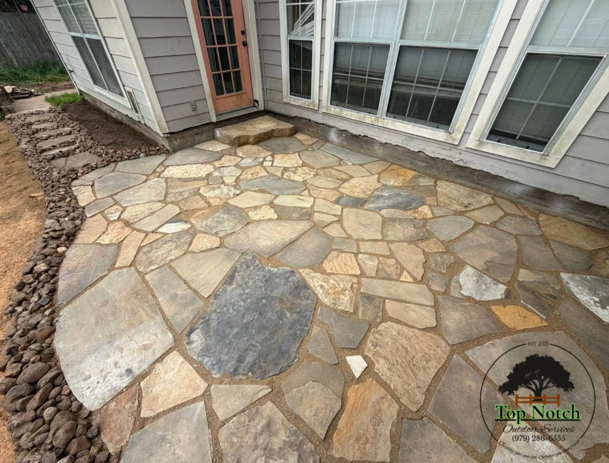 Detail of a finished flagstone patio with varied stone tones